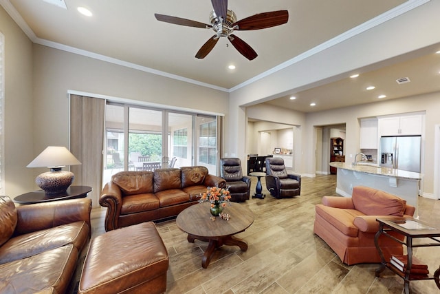 living area with baseboards, crown molding, and recessed lighting