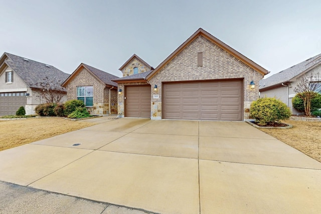 view of front of home with concrete driveway, brick siding, and an attached garage