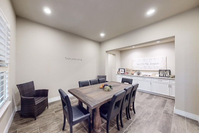 dining room with light wood-style flooring, baseboards, and recessed lighting