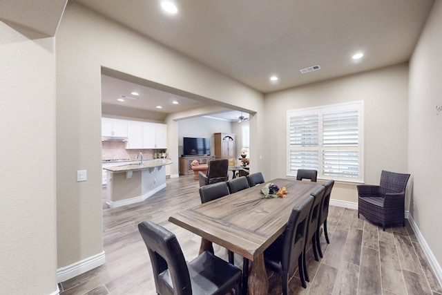 dining room featuring baseboards, recessed lighting, visible vents, and light wood-style floors