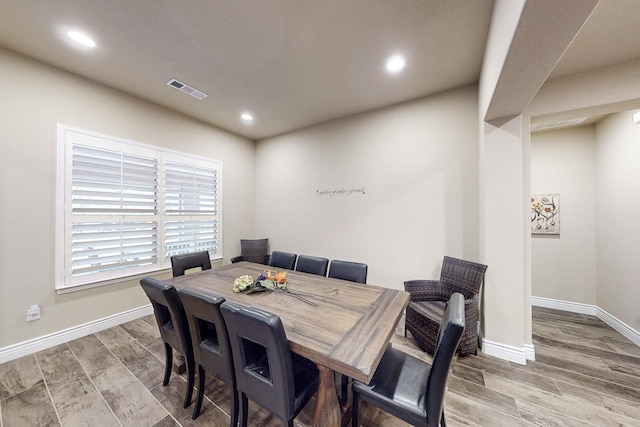 dining space featuring wood tiled floor, visible vents, baseboards, and recessed lighting