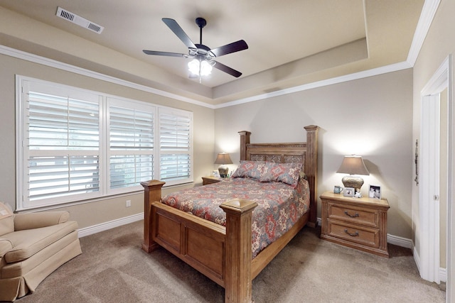 carpeted bedroom featuring a raised ceiling, visible vents, and baseboards