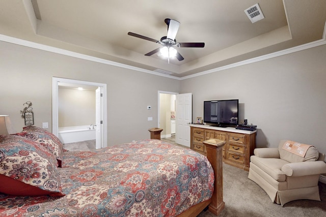 bedroom featuring a raised ceiling, visible vents, and light carpet