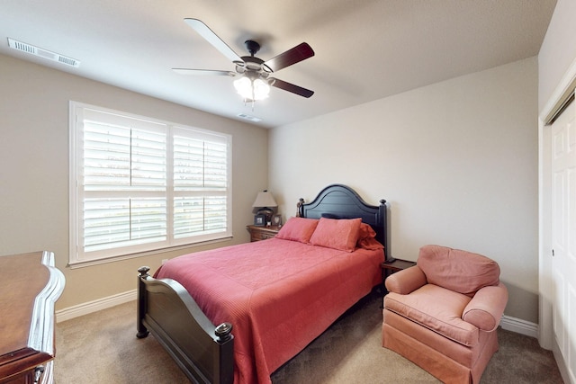 carpeted bedroom featuring a closet, visible vents, ceiling fan, and baseboards