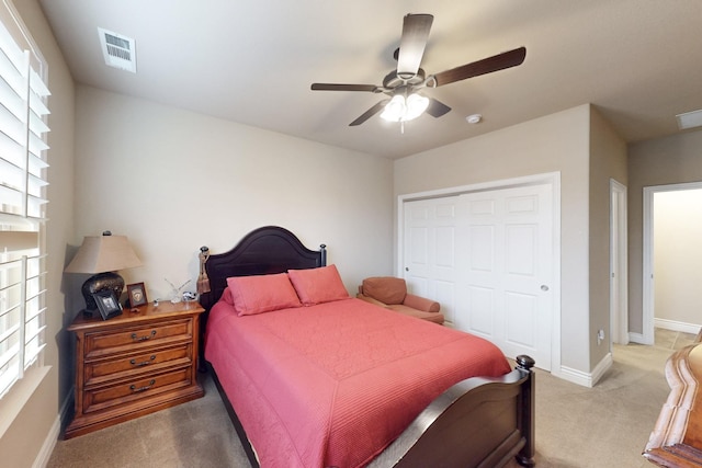 carpeted bedroom featuring multiple windows, a closet, visible vents, and baseboards