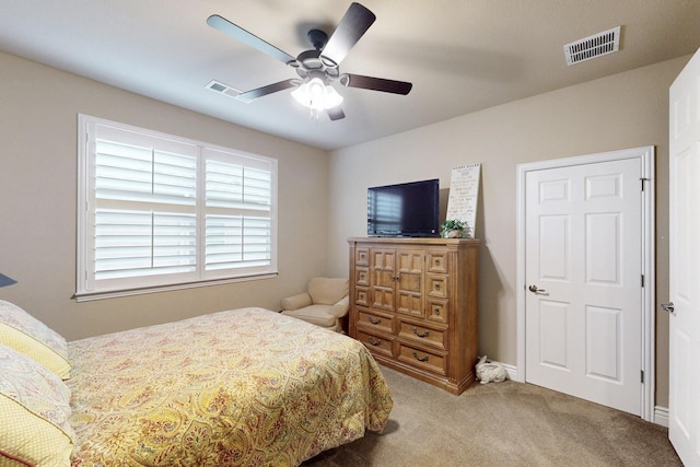 bedroom with carpet flooring, visible vents, and a ceiling fan