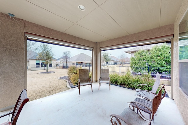 sunroom / solarium featuring a residential view