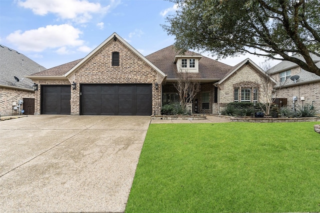 view of front of house featuring a garage and a front lawn