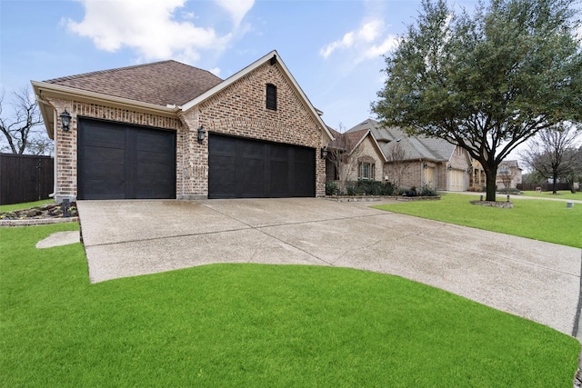 view of front of home with a garage and a front lawn