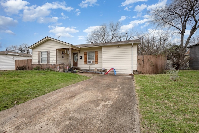 single story home with cooling unit and a front yard