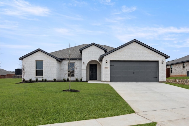 view of front of house featuring an attached garage, driveway, brick siding, and a front yard