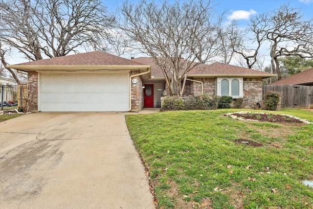 ranch-style house with an attached garage, brick siding, fence, driveway, and a front yard