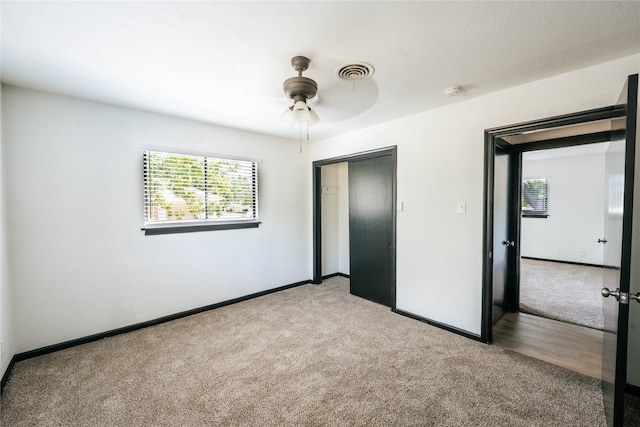 unfurnished bedroom with carpet floors, a closet, and ceiling fan