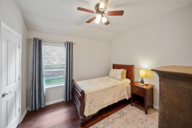 bedroom featuring vaulted ceiling, dark hardwood / wood-style floors, and ceiling fan