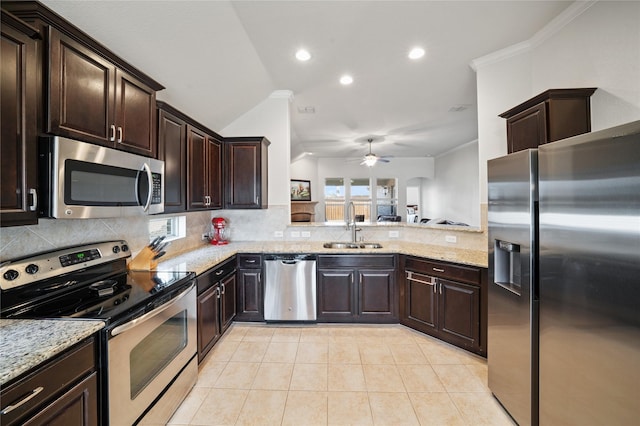 kitchen with appliances with stainless steel finishes, sink, decorative backsplash, ornamental molding, and light tile patterned floors