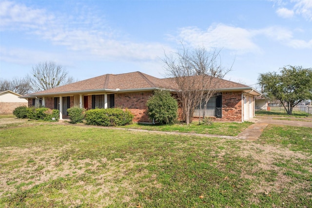 ranch-style home with a garage and a front yard