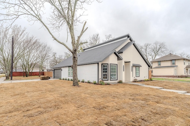 view of side of property featuring a yard and a garage