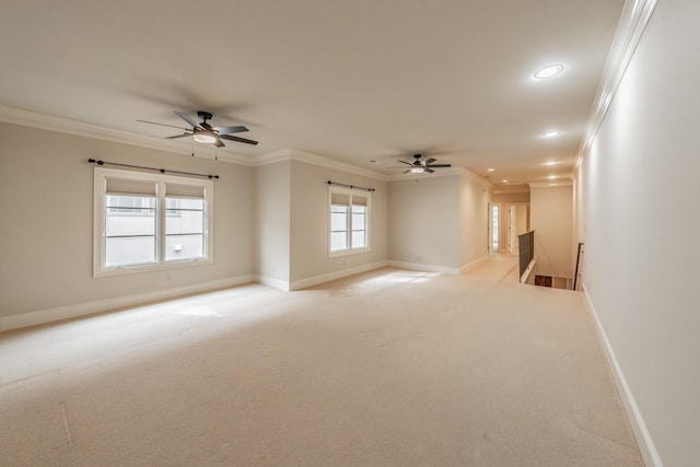 unfurnished room with ornamental molding, light carpet, and ceiling fan