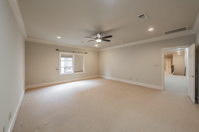 unfurnished room with crown molding, light colored carpet, and ceiling fan