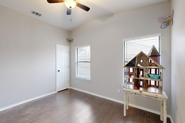 spare room featuring vaulted ceiling, dark hardwood / wood-style floors, and ceiling fan