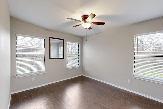 unfurnished room featuring dark wood-type flooring and ceiling fan