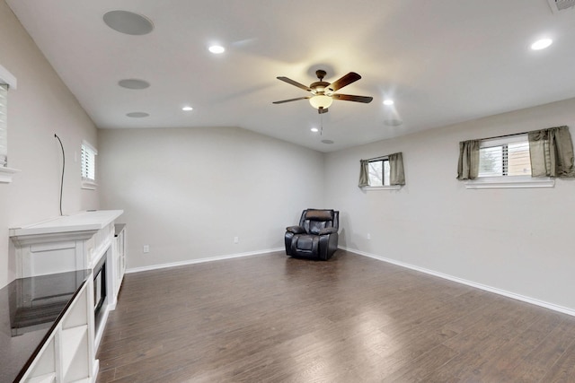 interior space with dark wood-type flooring, ceiling fan, plenty of natural light, and lofted ceiling