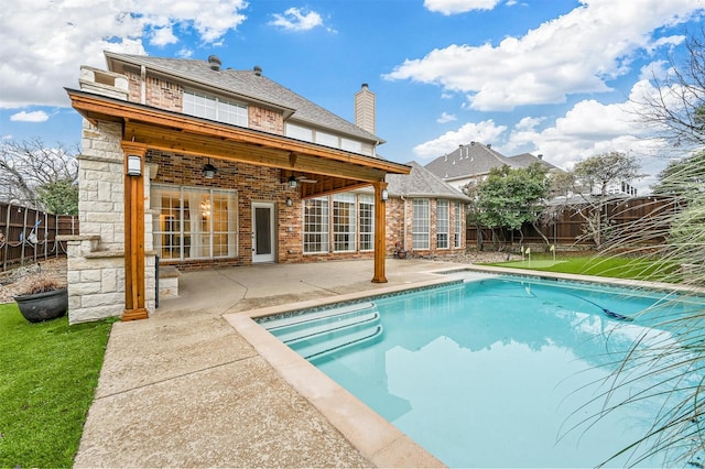 view of swimming pool featuring a patio and ceiling fan