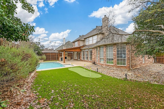 back of property featuring a fenced in pool and a patio area