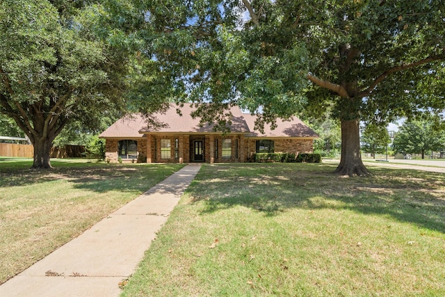 ranch-style home with a front lawn