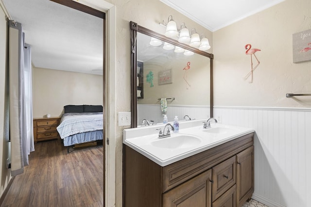609 S Elm St, Weatherford, TX 76086 - ensuite bathroom featuring a wainscoted wall, ensuite bath, a sink, and double vanity