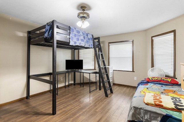 609 S Elm St, Weatherford, TX 76086 - bedroom with baseboards and wood finished floors