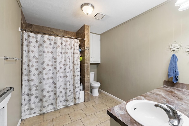 609 S Elm St, Weatherford, TX 76086 - bathroom with tile patterned floors, a shower with curtain, vanity, and toilet
