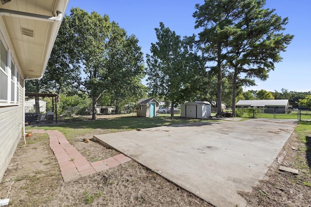 609 S Elm St, Weatherford, TX 76086 - view of yard featuring fence, a storage unit, an outbuilding, and a patio