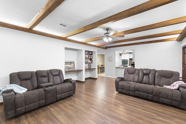 609 S Elm St, Weatherford, TX 76086 - living area with dark wood finished floors, beamed ceiling, visible vents, and ceiling fan with notable chandelier
