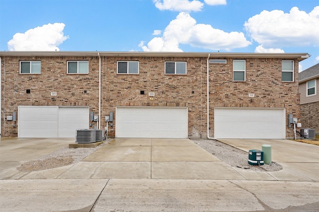 view of front of home with a garage and cooling unit