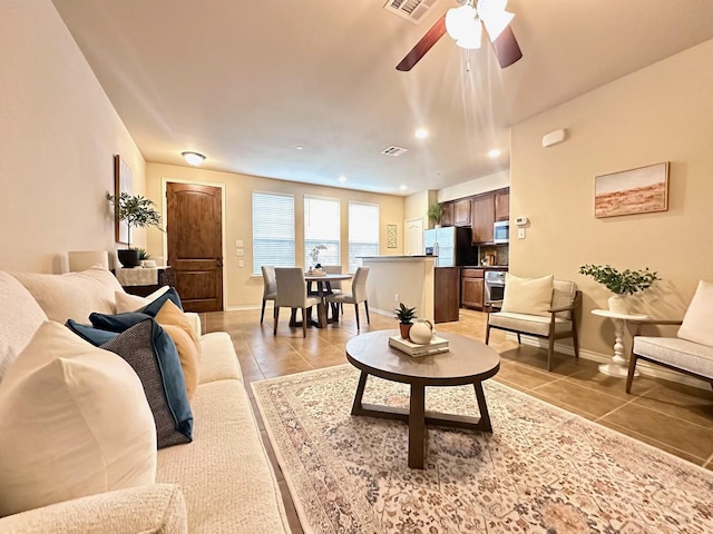 tiled living room featuring ceiling fan