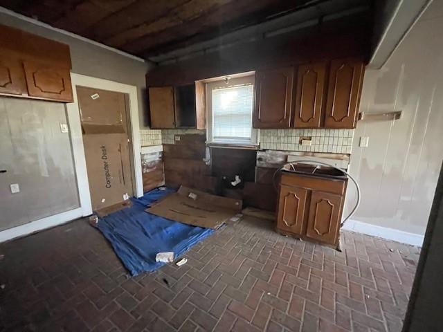 kitchen featuring tasteful backsplash and sink