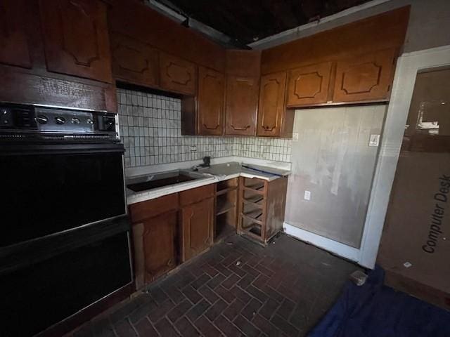 kitchen with backsplash and black electric stovetop