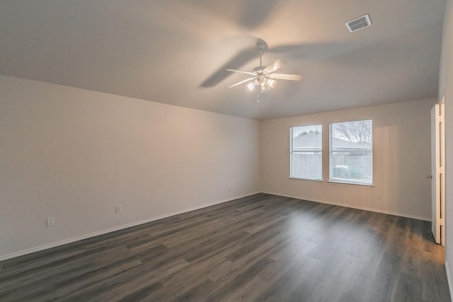 spare room featuring dark wood-type flooring, ceiling fan, and lofted ceiling