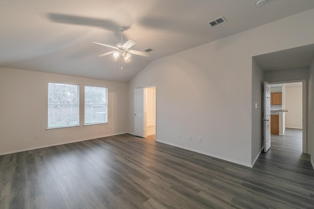 empty room with dark hardwood / wood-style flooring, lofted ceiling, and ceiling fan