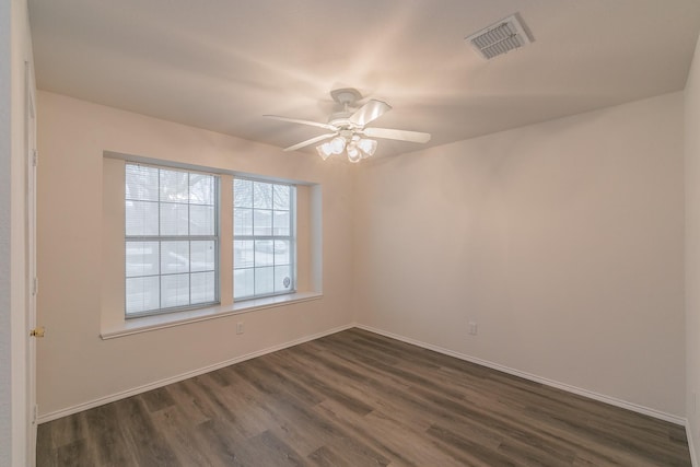 spare room featuring ceiling fan and dark hardwood / wood-style floors