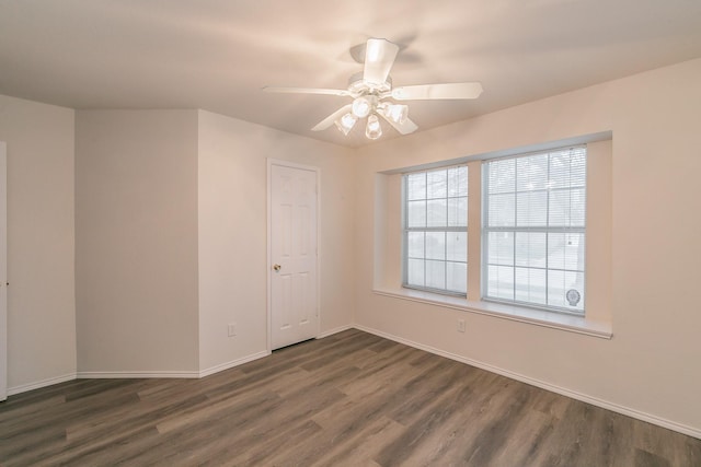 spare room featuring ceiling fan and dark hardwood / wood-style flooring