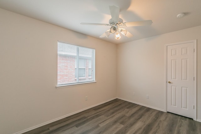 empty room featuring ceiling fan and dark hardwood / wood-style flooring