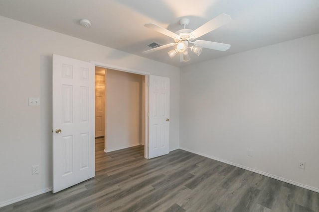 unfurnished bedroom with dark hardwood / wood-style flooring and ceiling fan