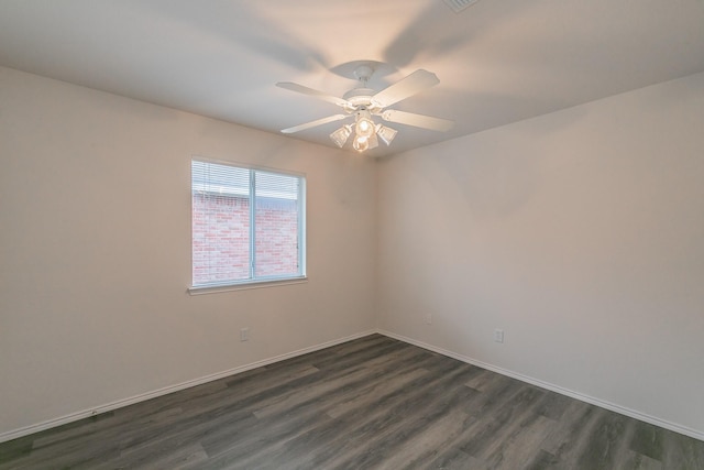 empty room with dark wood-type flooring and ceiling fan