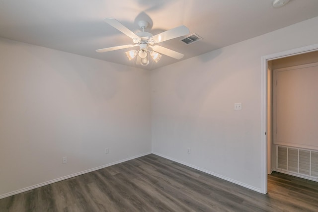 spare room with ceiling fan and dark hardwood / wood-style flooring