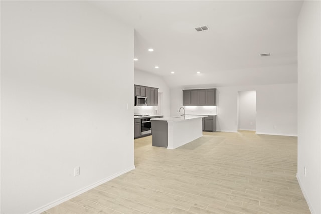 400 Basalt Dr, Azle, TX 76020 - kitchen featuring stainless steel microwave, open floor plan, baseboards, light countertops, and light wood-type flooring