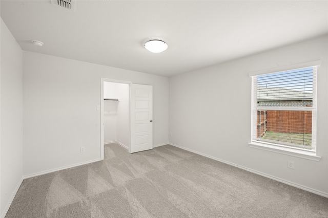 400 Basalt Dr, Azle, TX 76020 - unfurnished bedroom featuring light colored carpet, baseboards, a walk in closet, and a closet