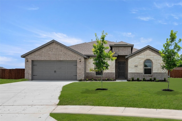 400 Basalt Dr, Azle, TX 76020 - french country style house featuring an attached garage, concrete driveway, brick siding, and roof with shingles