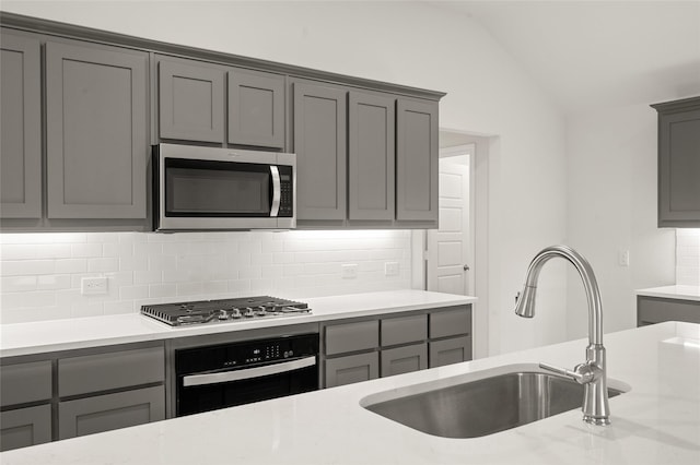 400 Basalt Dr, Azle, TX 76020 - kitchen with stainless steel appliances, gray cabinets, a sink, and lofted ceiling